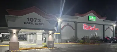 a hotel lobby with a neon sign in a parking lot at Red Roof Inn Bordentown - McGuire AFB in Bordentown