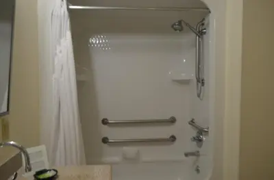 a shower stall in a bathroom with a shower curtain at Holiday Inn Express Hotel & Suites West Point-Fort Montgomery by IHG in Fort Montgomery