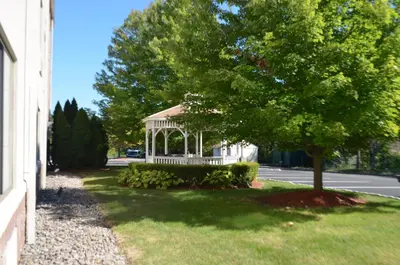 a white house with a gazebo in the yard at Holiday Inn Express Hotel & Suites West Point-Fort Montgomery by IHG in Fort Montgomery