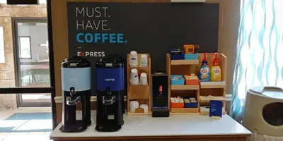 a coffee shop with a bunch of bottles on a table at Holiday Inn Express Hotel & Suites West Point-Fort Montgomery by IHG in Fort Montgomery