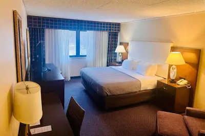 a hotel room with a bed and a couch at Quality Inn Horseheads in Horseheads