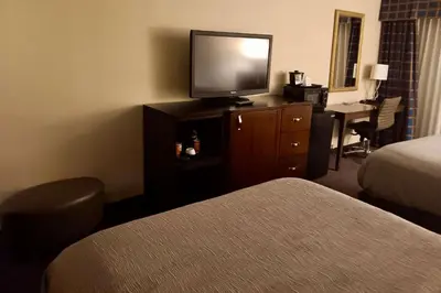 a hotel room with a television on a dresser with a bed at Quality Inn Horseheads in Horseheads