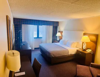 a hotel room with a bed and a couch at Quality Inn Horseheads in Horseheads