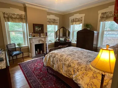 a bedroom with a bed and a fireplace at Hollinger House in Lancaster