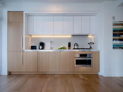 a kitchen with white cabinets and a sink at Global Luxury Suites at Sky in New York