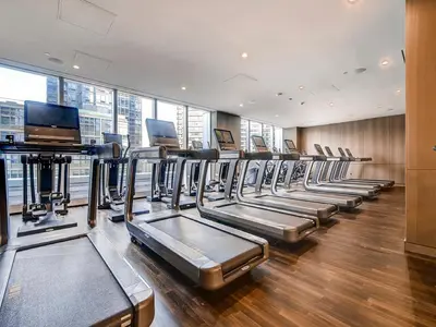 a row of treadmills in a gym at Global Luxury Suites at Sky in New York