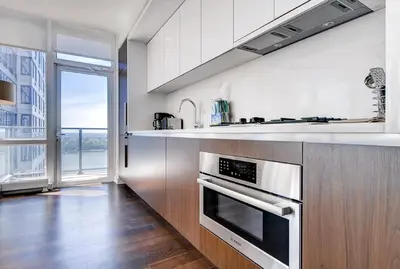 a kitchen with a sink and a stove top oven at Global Luxury Suites at Sky in New York
