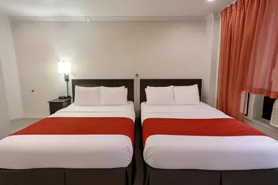 two beds sitting next to each other in a room at Heritage Hotel New York City in New York