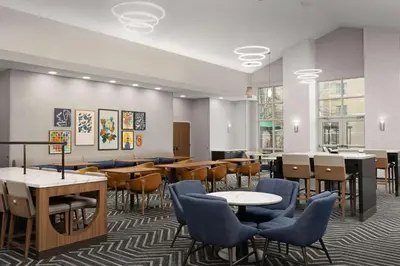 a dining room with tables and chairs and a cafeteria at Homewood Suites by Hilton York in York