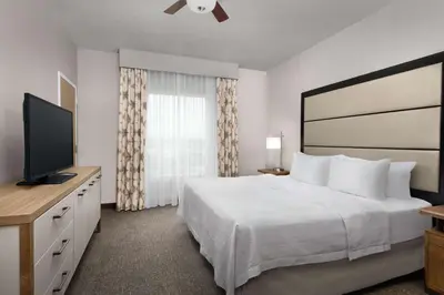 a hotel room with a bed and a flat screen tv at Homewood Suites by Hilton York in York