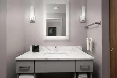 a bathroom with a white sink and a mirror at Homewood Suites by Hilton York in York
