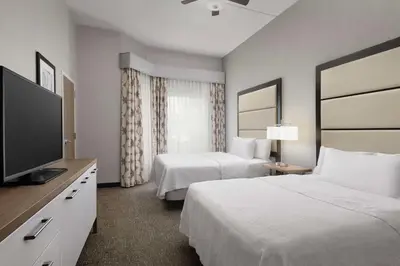 a hotel room with two beds and a flat screen tv at Homewood Suites by Hilton York in York