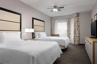 a hotel room with two beds and a flat screen tv at Homewood Suites by Hilton York in York