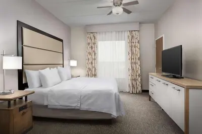 a hotel room with a bed and a flat screen tv at Homewood Suites by Hilton York in York