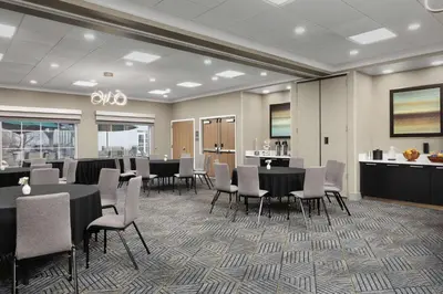 a conference room with tables and chairs and a counter at Homewood Suites by Hilton York in York