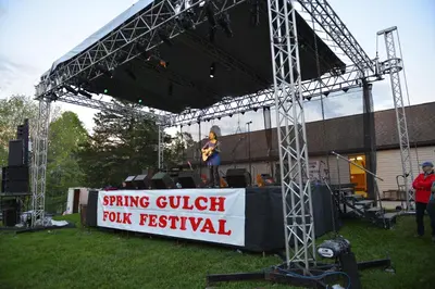 a person standing on a stage at a music festival at Spring Gulch Lakefront Park Model 5 in Mount Airy