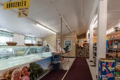a grocery store aisle with a food counter in a store at Spring Gulch Lakefront Park Model 5 in Mount Airy