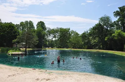 a group of people swimming in a pond at Spring Gulch Country House 9 in Mount Airy