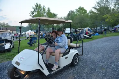 a man and woman sitting on a golf cart at Spring Gulch Country House 9 in Mount Airy