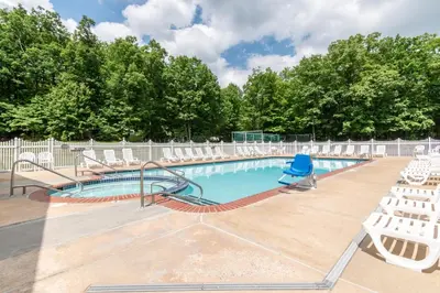 a swimming pool with chairs and a slide at Spring Gulch Lodge 11 in Mount Airy