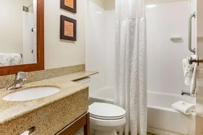 a bathroom with a sink and a toilet and a tub at Comfort Inn Lancaster at Rockvale in Lancaster
