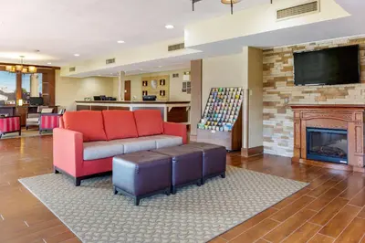 a living room with a couch and a fireplace at Comfort Inn Lancaster at Rockvale in Lancaster