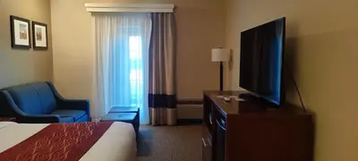 a hotel room with a bed and a flat screen tv at Comfort Inn Lancaster at Rockvale in Lancaster