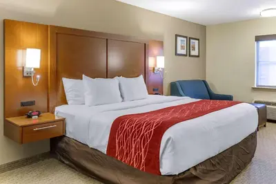 a hotel room with a large bed with a red blanket at Comfort Inn Lancaster at Rockvale in Lancaster