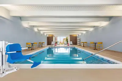 a pool in a hotel with a blue swimming pool at Home2 Suites By Hilton York in York