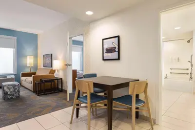 a living room with a dining room table and chairs at Home2 Suites By Hilton York in York