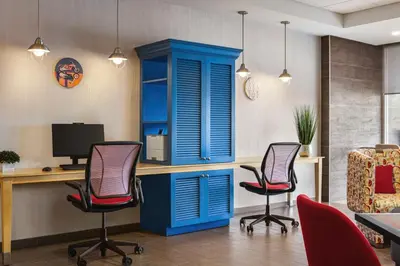 an office with a blue cabinet and three chairs at Home2 Suites By Hilton York in York