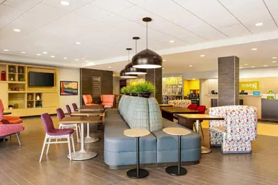 a lobby with chairs and a couch and tables at Home2 Suites By Hilton York in York