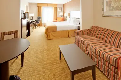 a hotel room with a couch and a bed at Holiday Inn Express Hotel & Suites Lebanon by IHG in Lebanon