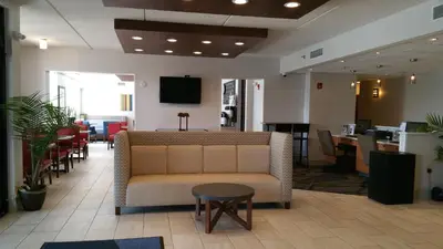 a waiting room with a couch and a table at Holiday Inn Express Harrisburg East by IHG in Harrisburg