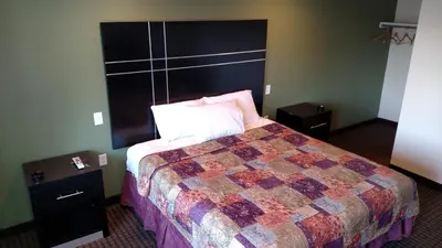 a hotel room with a bed and two night stands at Gene's Motel in Cinnaminson