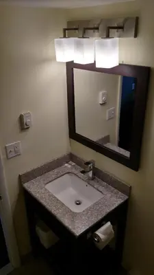 a bathroom with a sink and a mirror at Gene's Motel in Cinnaminson