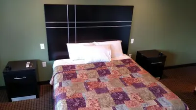 a hotel room with a bed and two night stands at Gene's Motel in Cinnaminson