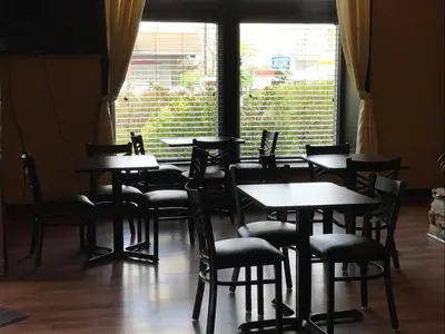 a dining room with tables and chairs and a window at Soudersburg Inn & Suites Lancaster in Ronks