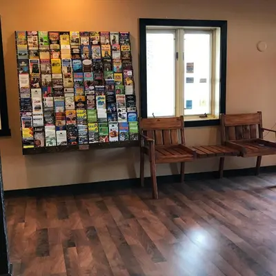 a room with two wooden benches and a window at Soudersburg Inn & Suites Lancaster in Ronks