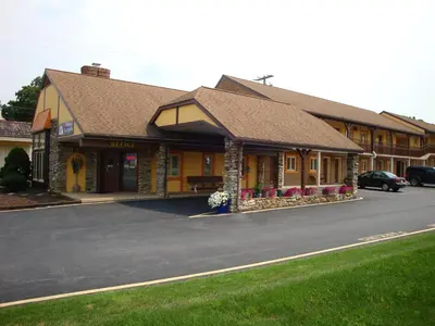 a building on a street with a car parked in front at Soudersburg Inn & Suites Lancaster in Ronks