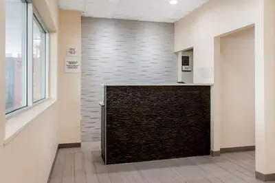 a lobby with a large stone wall in a building at Escape Inn Hershey in Hershey