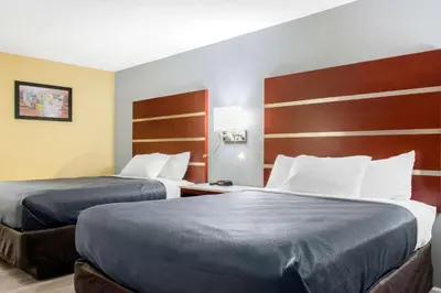 a hotel room with two beds in a room at Escape Inn Hershey in Hershey