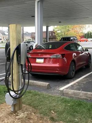 a red car is parked in a parking lot at Escape Inn Hershey in Hershey