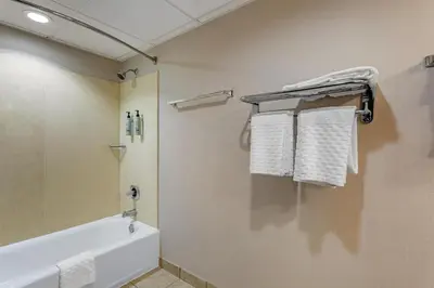 a bathroom with a tub and towels on a wall at Best Western Hunt's Landing Hotel Matamoras Milford in Matamoras