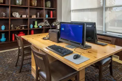 a desk with a computer monitor and a keyboard and mouse at Four Points Philadelphia City Center in Philadelphia