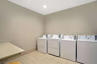 a laundry room with two washes and two washers at La Quinta by Wyndham York in York