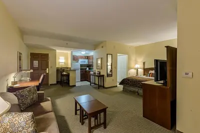 a hotel room with two beds and a living room at Staybridge Suites Harrisburg-Hershey by IHG in Harrisburg