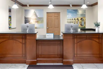 two laptops sitting on top of wooden cabinets in a room at Staybridge Suites Harrisburg-Hershey by IHG in Harrisburg