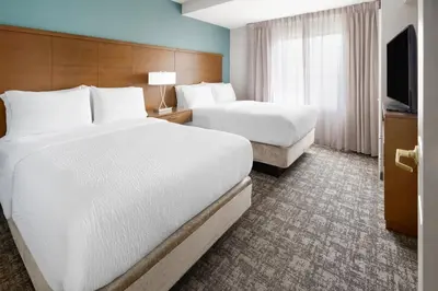 a hotel room with two beds and a television at Staybridge Suites Harrisburg-Hershey by IHG in Harrisburg