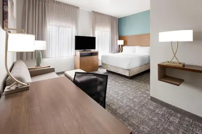 a hotel room with a bed and a desk at Staybridge Suites Harrisburg-Hershey by IHG in Harrisburg